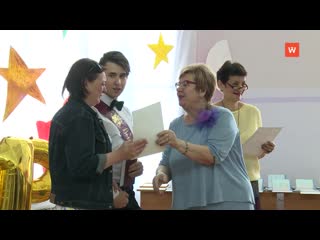 graduates leave the school walls